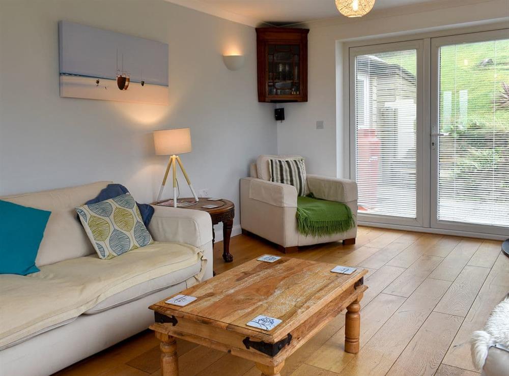 Living room with French doors leading to garden (photo 2) at Sea Otter in Porthtowan, Cornwall