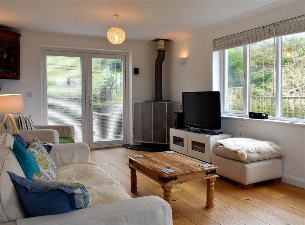 Living room with French doors leading to garden at Sea Otter in Porthtowan, Cornwall