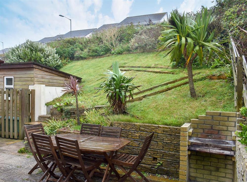 Rear garden with patio, garden furniture and BBQ at Sea Otter in Porthtowan, Cornwall