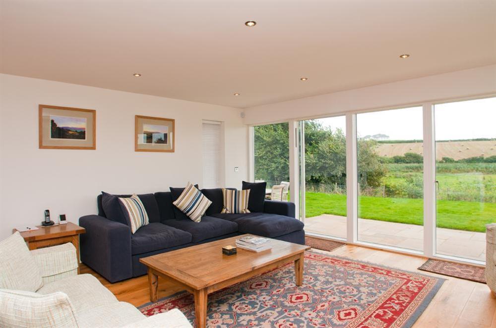 Sitting room has French doors out to garden at Sea Peep in Whimbrels Edge, Thurlestone