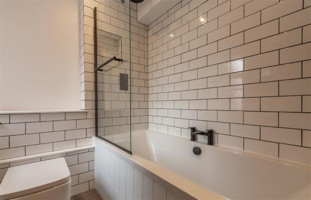 First floor: A fully tiled bathroom at Sea Shanty Cottage, Wells-next-the-Sea