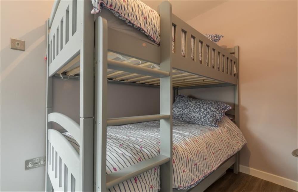 First floor: Bedroom three with full-size bunk beds at Sea Shanty Cottage, Wells-next-the-Sea