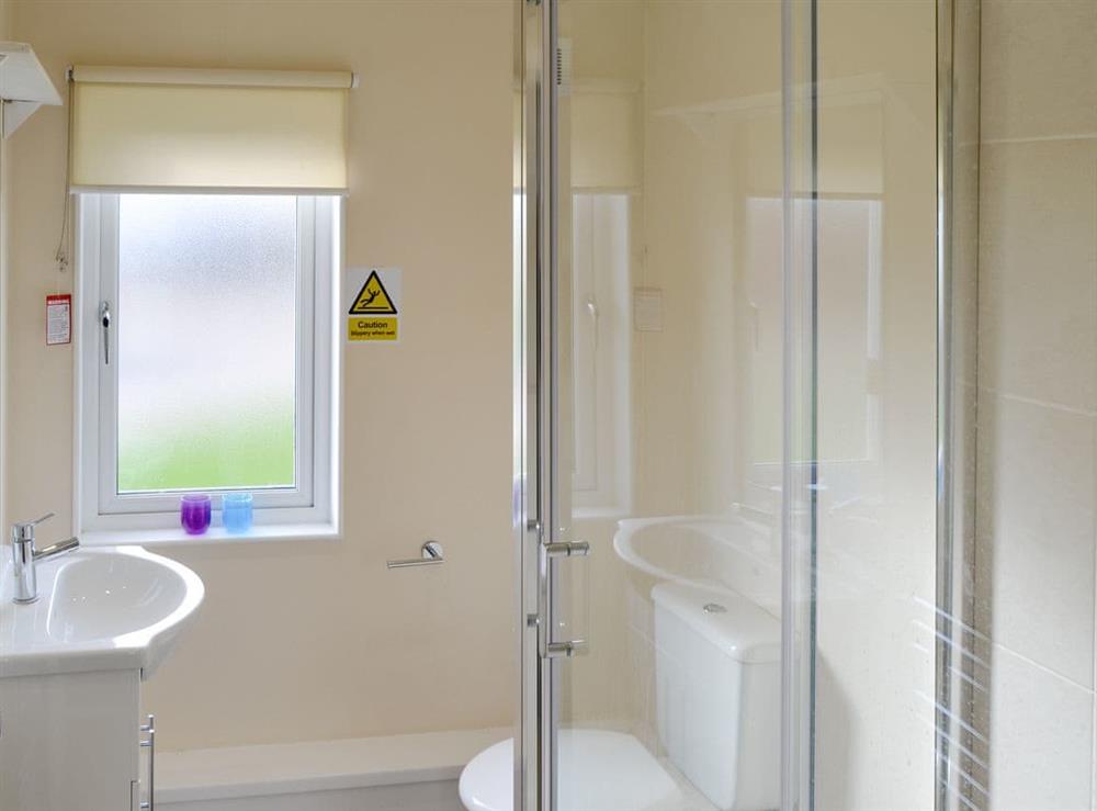Family shower room with heated towel rail at Sea Space in Bacton, Norfolk