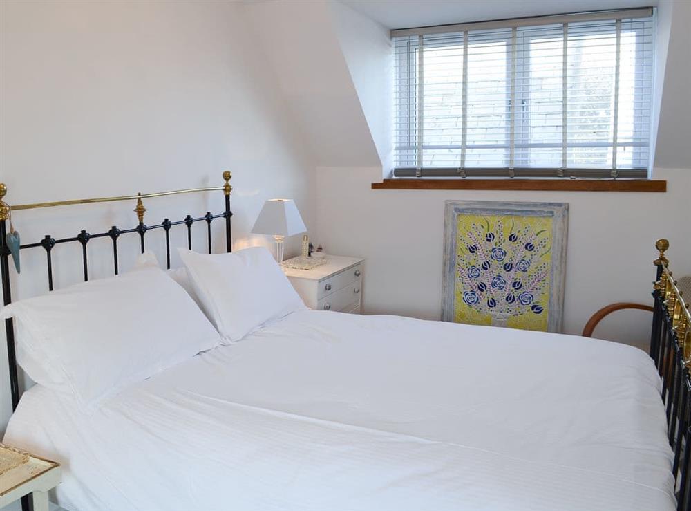 Delightful bedroom with antique style double bed at Sea Thistle Cottage in Nairn, Highlands, Morayshire