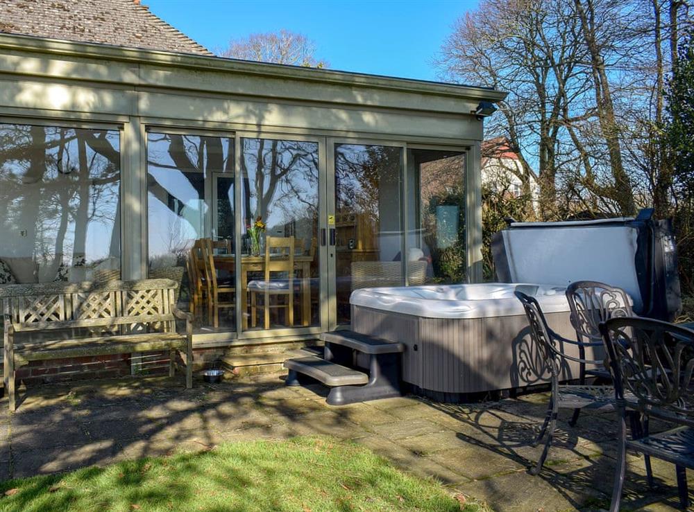 Terrace with furniture and hot tub at Sea View Lodge in Rousdon, near Lyme Regis, Devon