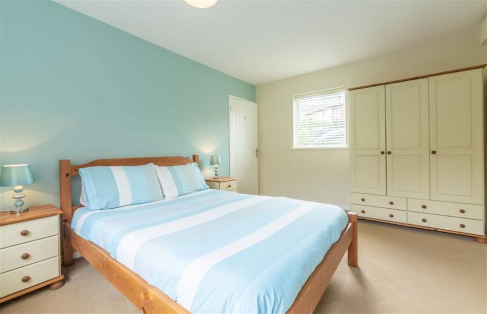 Ground floor: Large wardrobe and king-size bed in Master bedroom at Sea Wind, Brancaster near Kings Lynn