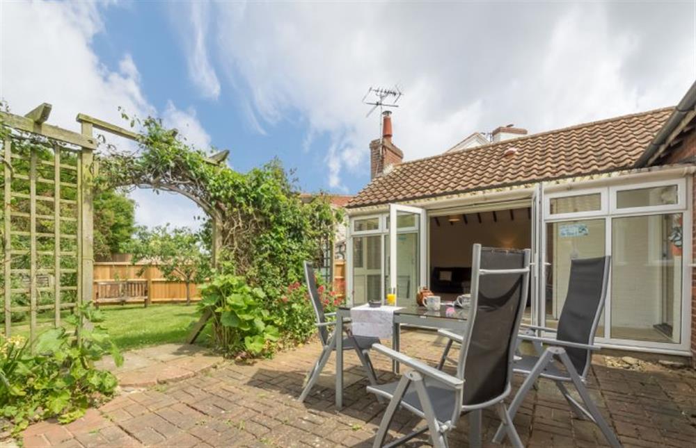 The enclosed garden has terraced and lawned areas at Sea Wind, Brancaster near Kings Lynn
