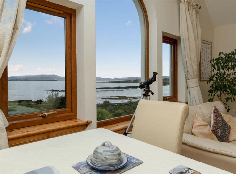 Open plan living space with magnificent views over Broadford Bay (photo 2) at Seabird Cottage in Broadford, Isle of Skye., Isle Of Skye