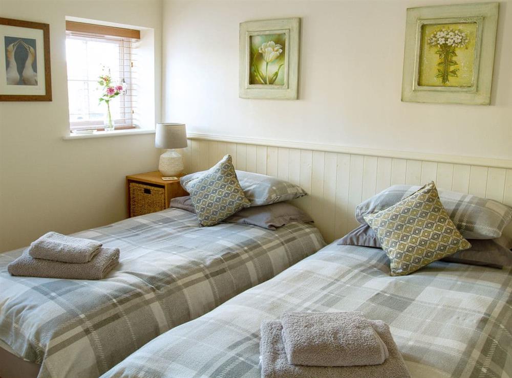 Relaxing bedroom with en-suite shower room at Gannet Lodge, 