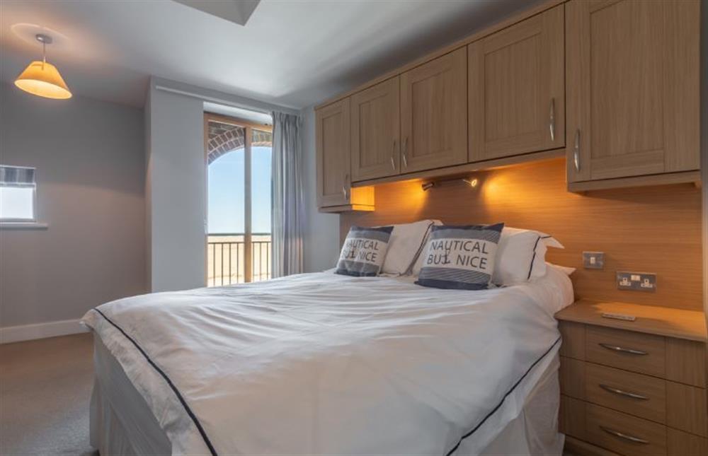 King size bedroom with door to Juliette balcony at Seaborne, Wells-next-the-Sea