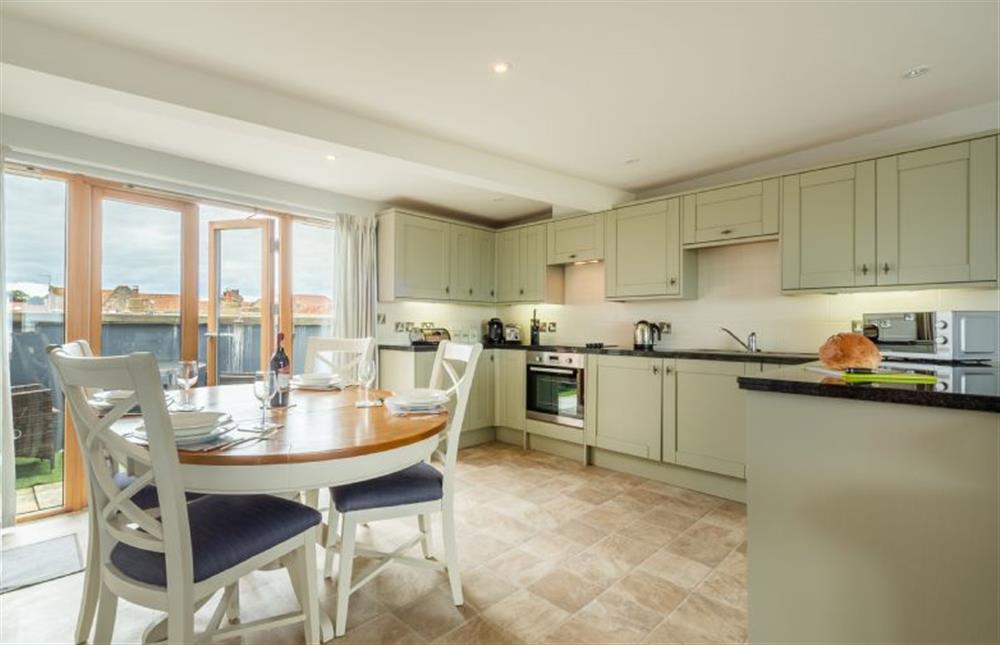 Kitchen/dining area with table and seating for four and plenty of cupboard space at Seaborne, Wells-next-the-Sea