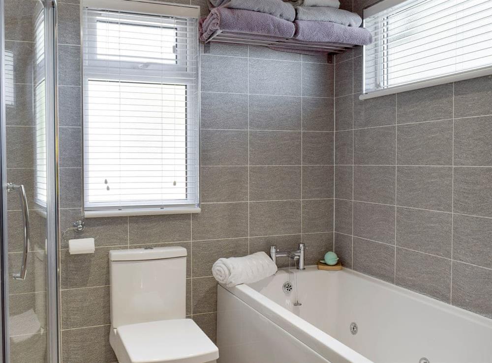 En-suite with Jacuzzi bath and shower cubicle at Seacliff in Corton, near Lowestoft, Suffolk