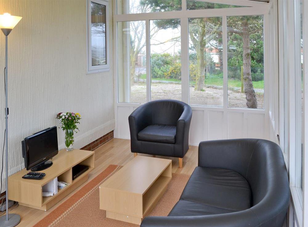 Conservatory with seating and TV at Seacroft in East Runton, near Cromer, Norfolk