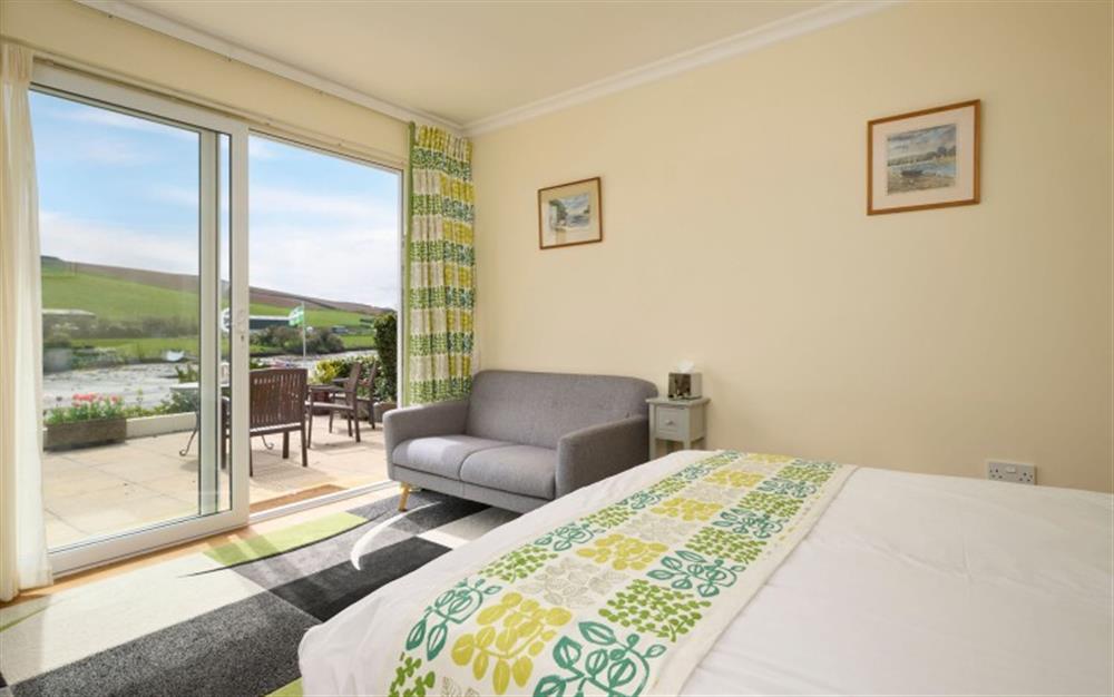 Bedroom 5 -with space to relax, and french doors to the terrace-and of course those gorgeous views at Seaflowers in Frogmore