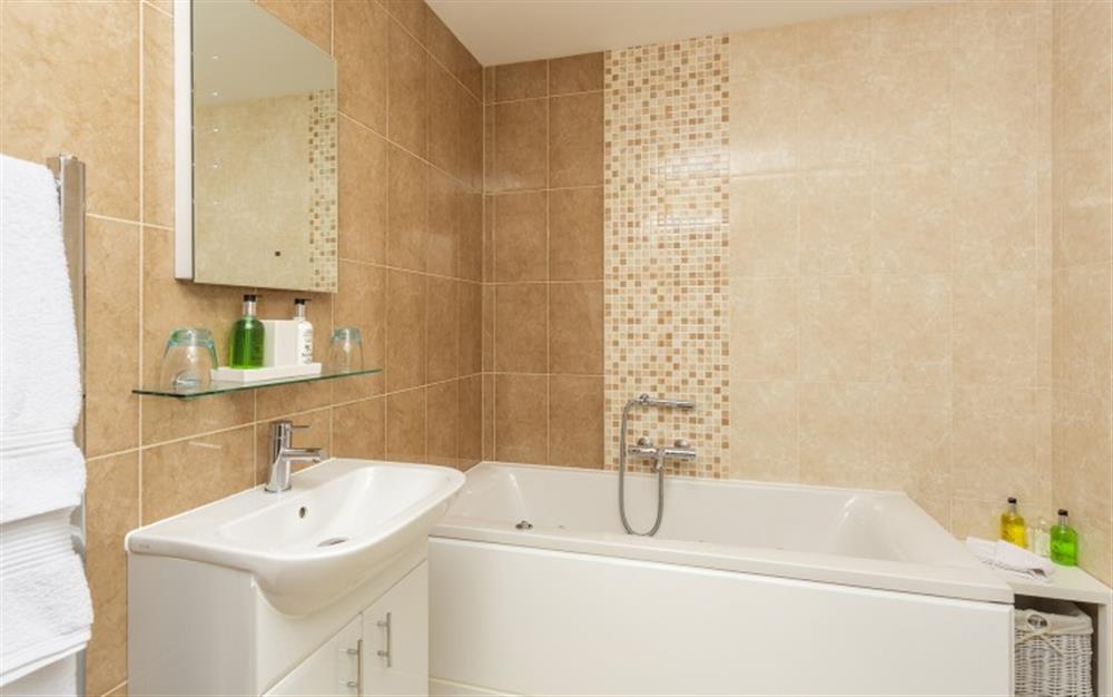 The en suite bathroom for bedroom 1 with separate shower at Seaflowers in Frogmore
