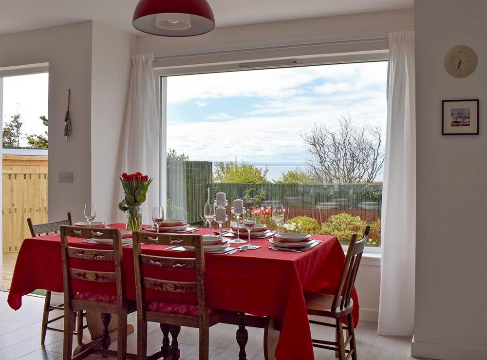 Dining area with patio doors leading to decking at Seaforth View in St Monans, near Anstruther, Fife