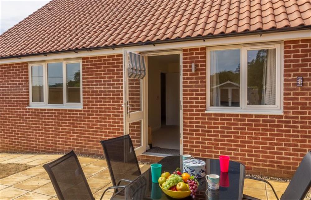 Garden:  With patio area with table with seating for four at Seagrace, Heacham near Kings Lynn