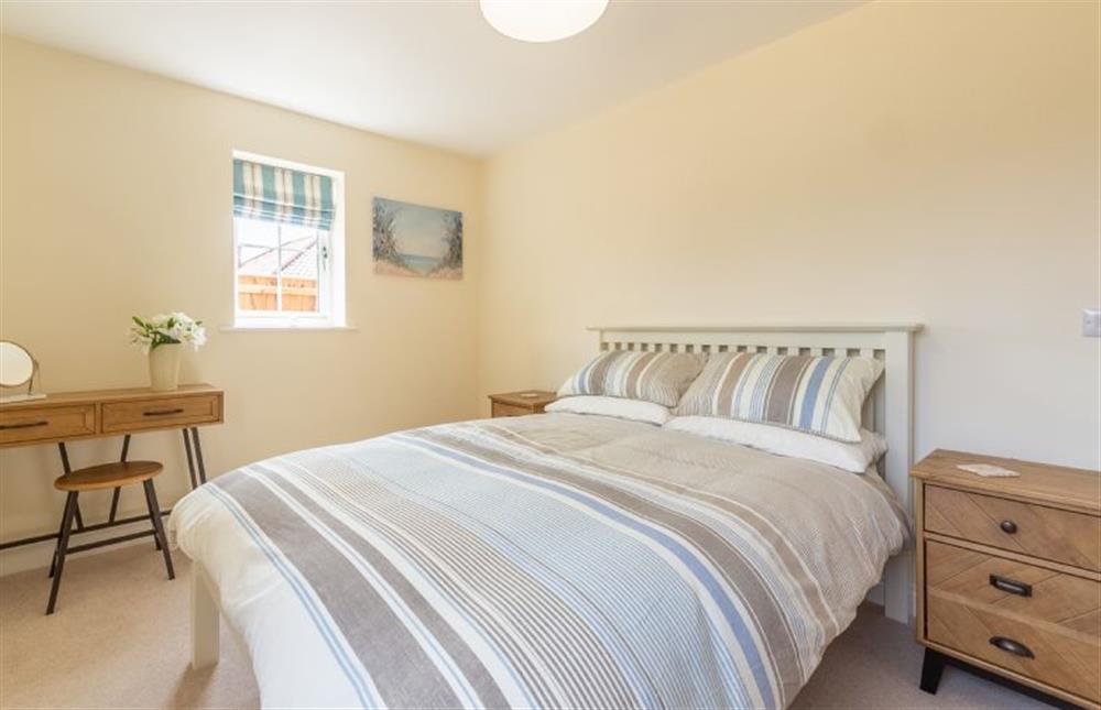 Ground floor:  Master bedroom with double bed and dressing table at Seagrace, Heacham near Kings Lynn