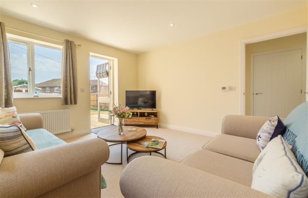 Ground floor:  Sitting room with comfy sofas and flatscreen television at Seagrace, Heacham near Kings Lynn
