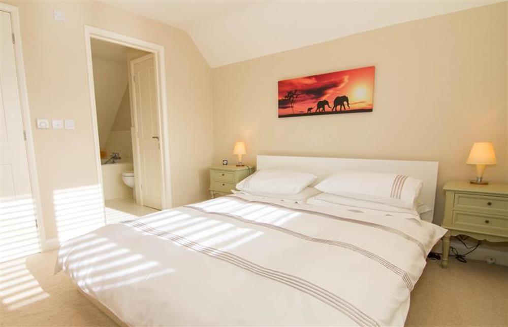 First floor: Bright Master bedroom has en-suite bathroom at Seagrass, Thornham near Hunstanton