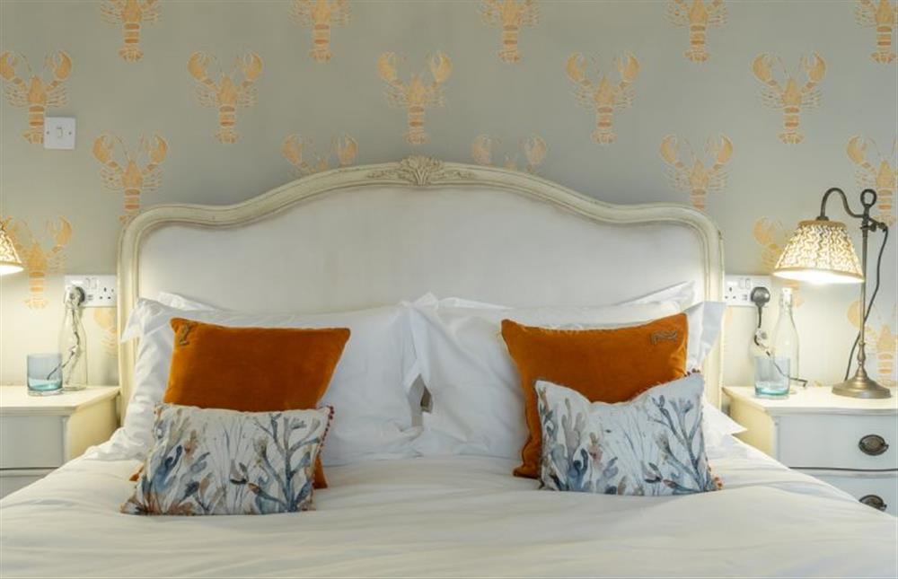 First floor: Master bedroom boasts a king-size bed at Seagull Cottage, Hunstanton
