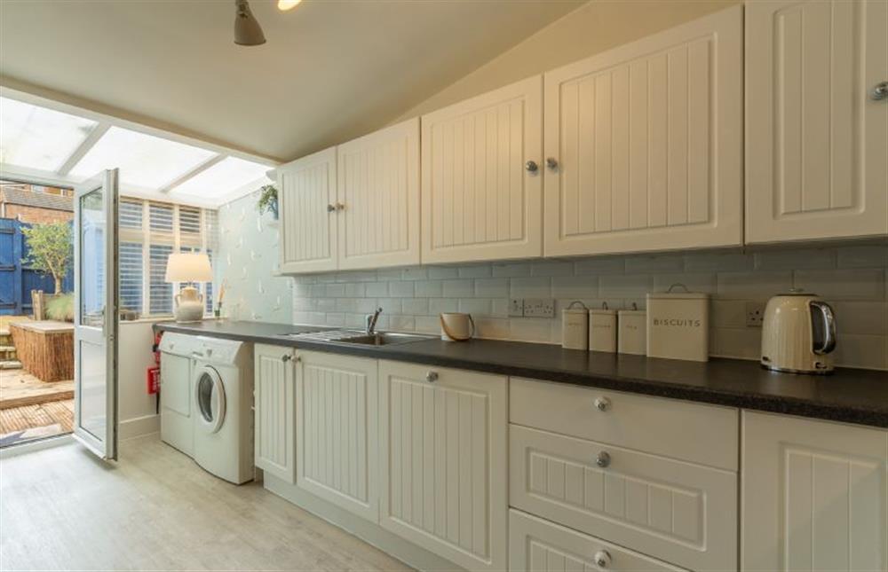Ground floor: Kitchen has a door out onto the south-facing terrace at Seagull Cottage, Hunstanton