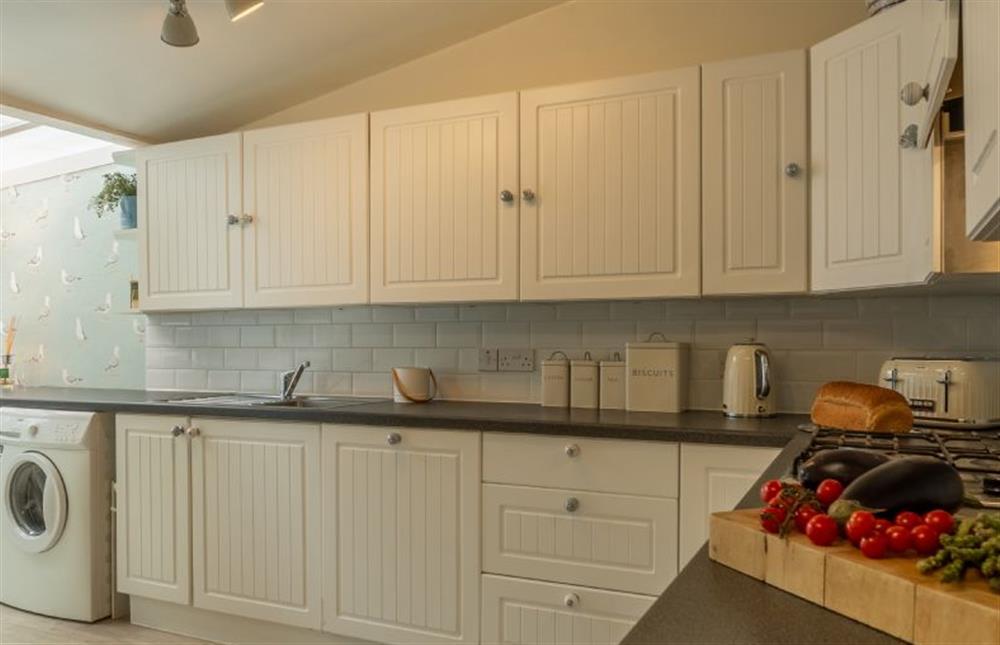 Ground floor: Kitchen with a washing machine and tumble dryer at Seagull Cottage, Hunstanton