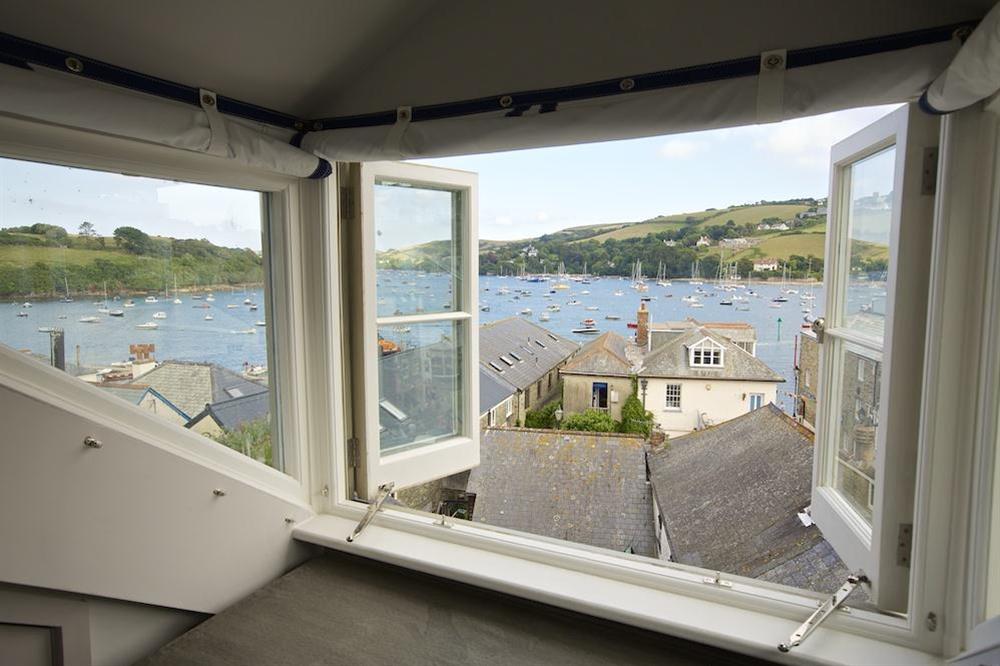 Look out over the roof tops towards the harbour at Seagull Cottage in , Salcombe