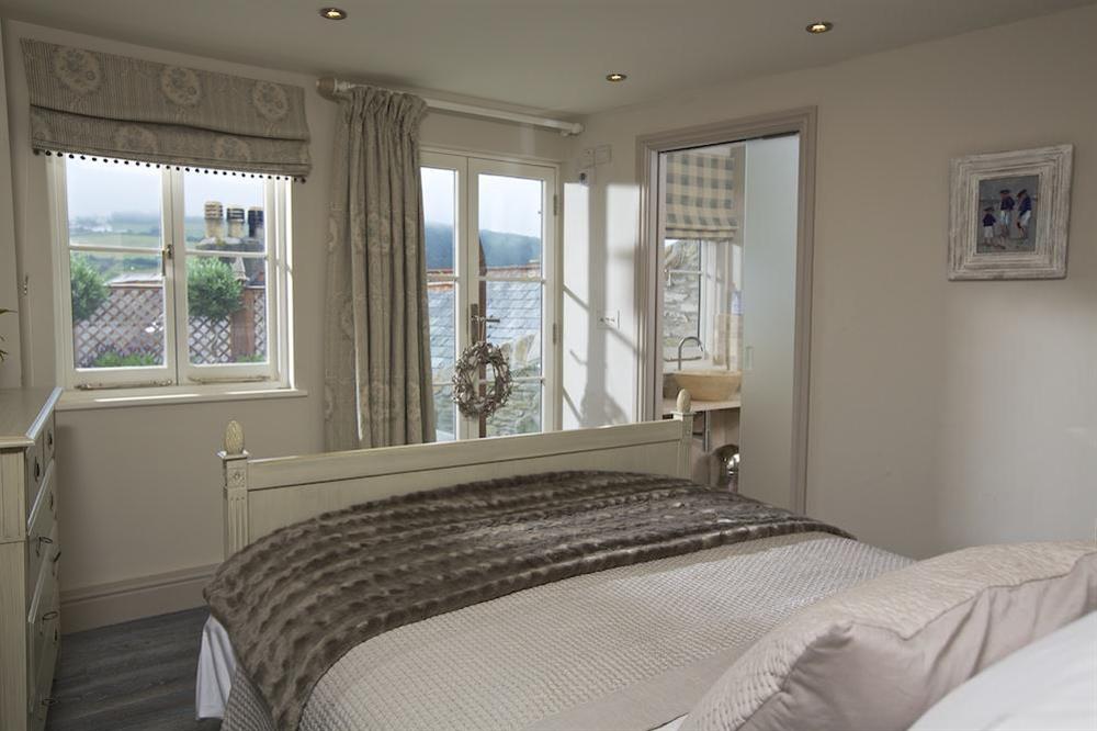 Master bedroom with doors out to the decking at Seagull Cottage in , Salcombe
