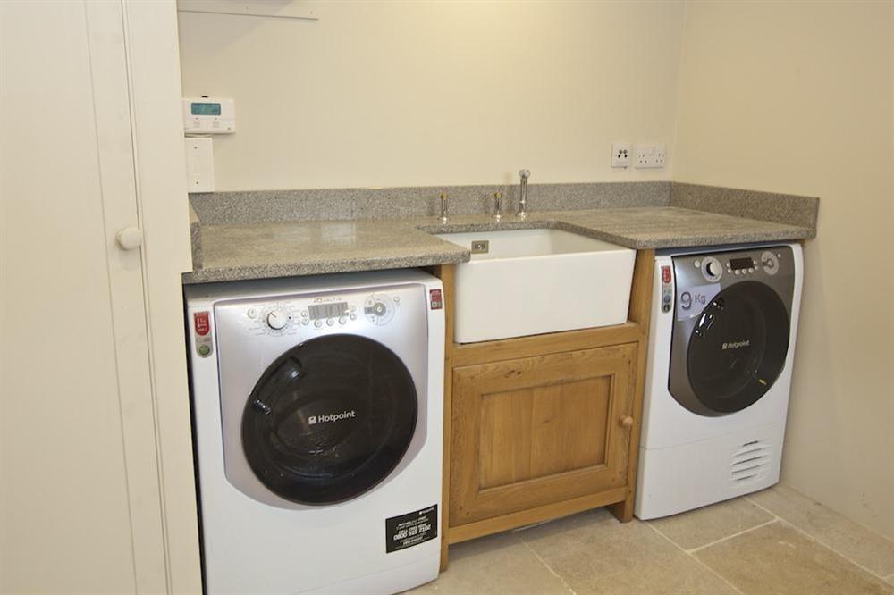 Utility room with washing machine and tumble dryer at Seagull Cottage in , Salcombe