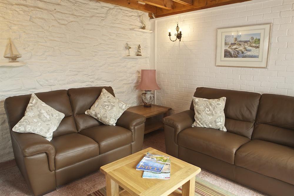 Archway leads into a cosy lounge with two double leather sofas at Seagulls (Salcombe) in Fore Street, Salcombe
