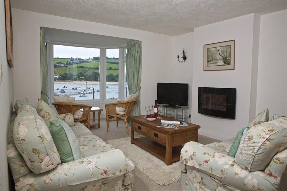Comfortable sitting room with a large bay window offering superb views over the harbour at Seagulls (Salcombe) in Fore Street, Salcombe