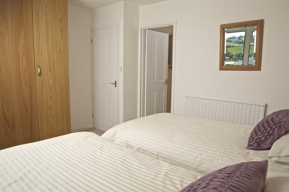 Master bedroom with two single beds (pushed together) and a door out to sun terrace with lovely views (photo 2) at Seagulls (Salcombe) in Fore Street, Salcombe