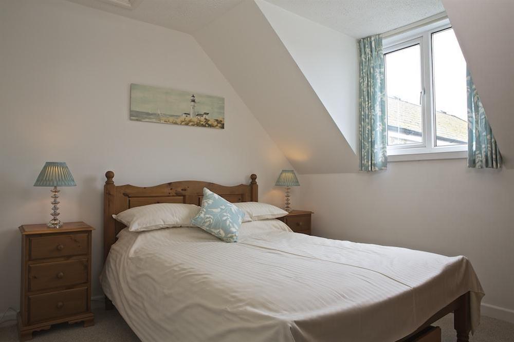 Pine double bed on the second floor at Seagulls (Salcombe) in Fore Street, Salcombe