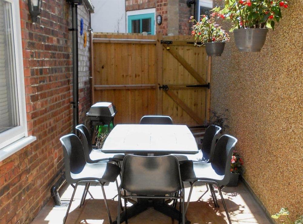 Courtyard with patio, garden furniture and gas barbecue at Little Seahorse, 