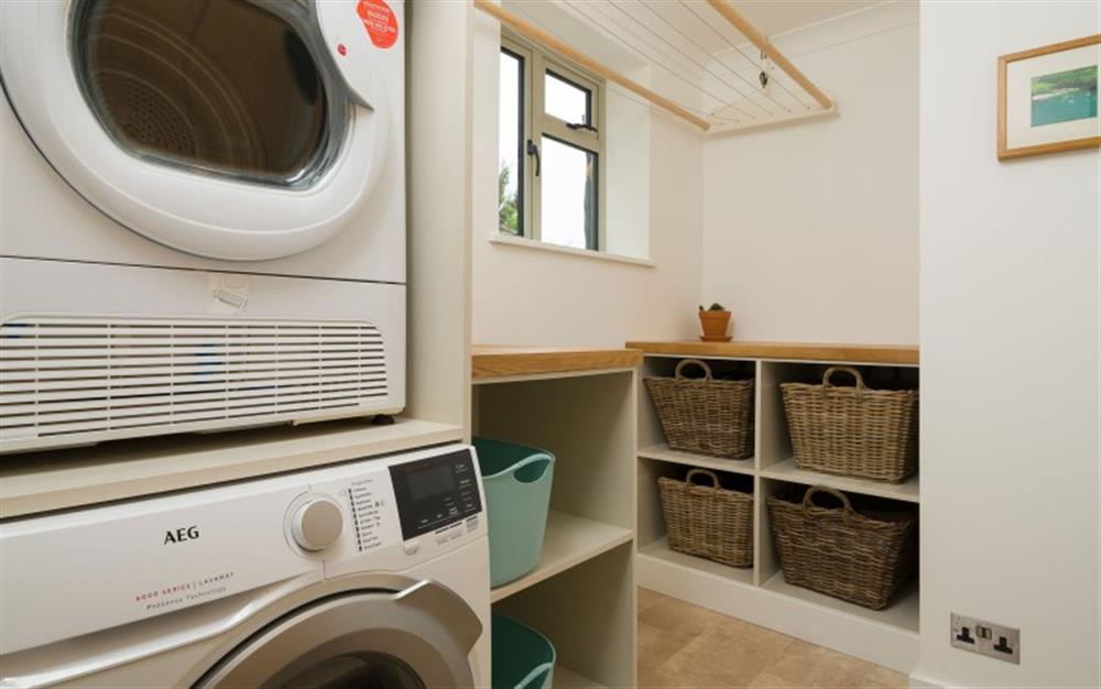 Laundry room with washing machine and tumble dryer at Seahorses in Newton Ferrers