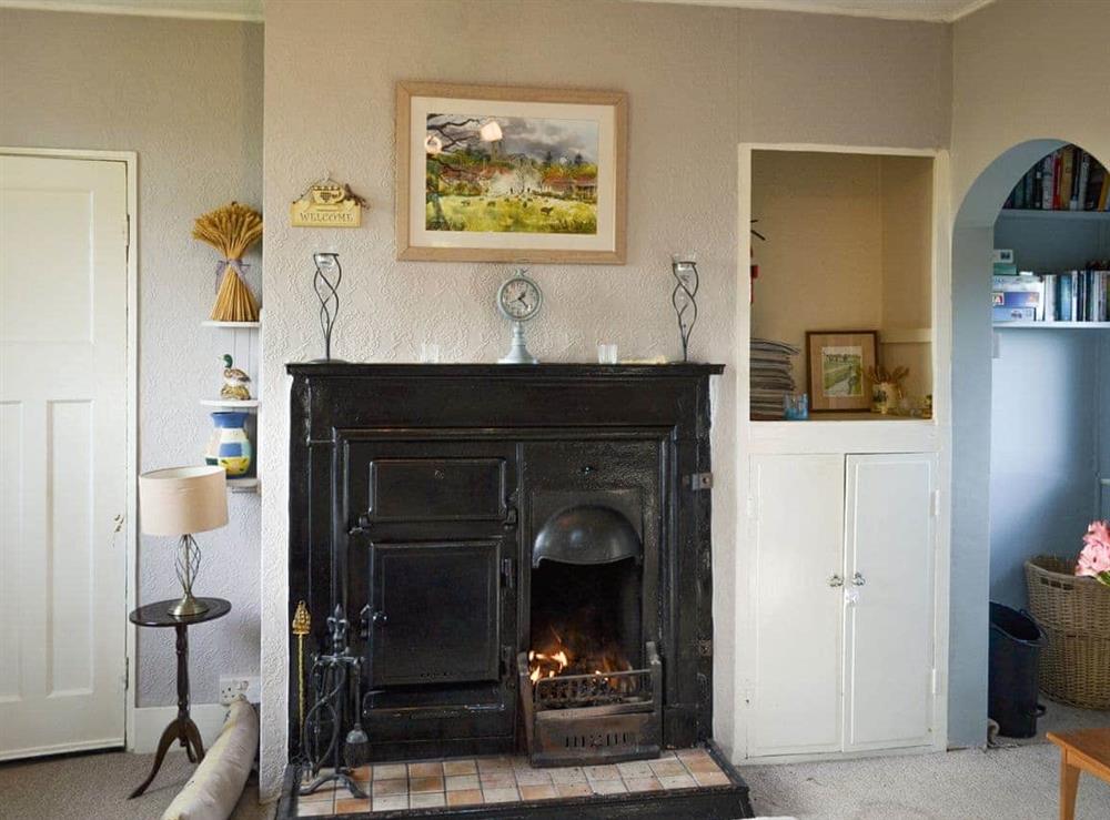 Heritage feature fireplace within the living room at Searchlight Cottage in Fraisthorpe, near Bridlington, North Humberside