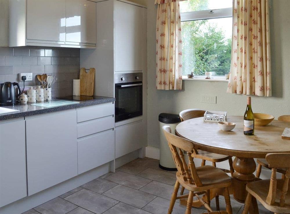 Well-equipped kitchen with dining area at Searchlight Cottage in Fraisthorpe, near Bridlington, North Humberside