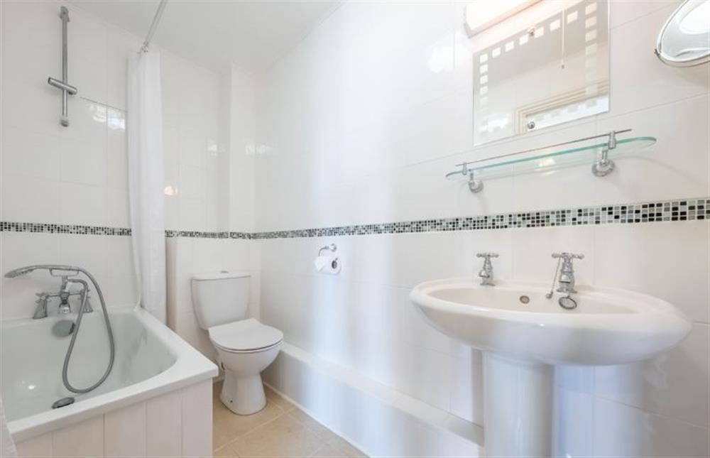 En-suite bathroom with bath and shower over at Seas the Day, Sheringham