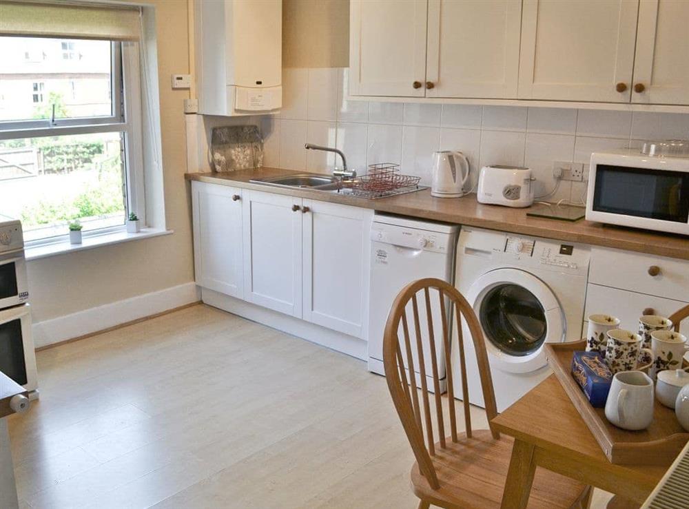 Kitchen with small dining area at Seasands in Sheringham, Norfolk