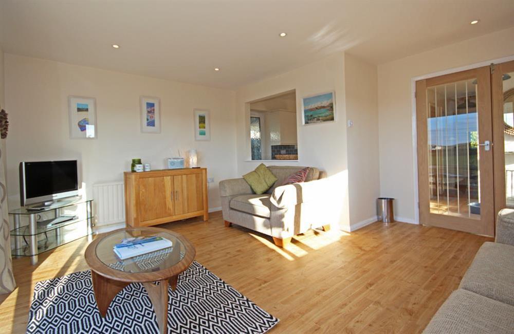 Comfortable lounge with new wooden flooring (photo 2) at Seascape (Hope Cove) in 23 Weymouth Park, Hope Cove