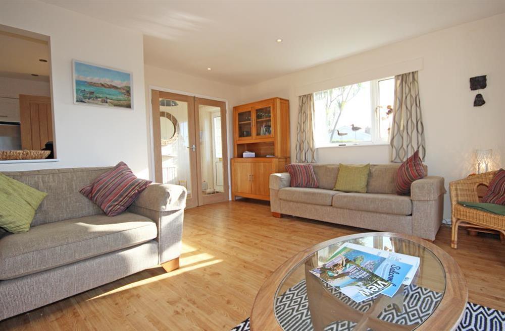 Comfortable lounge with new wooden flooring (photo 3) at Seascape (Hope Cove) in 23 Weymouth Park, Hope Cove