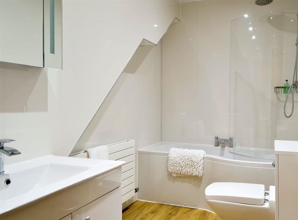 Bathroom with shower over the bath at Seascape Cottage in Allonby, near Maryport, Cumbria