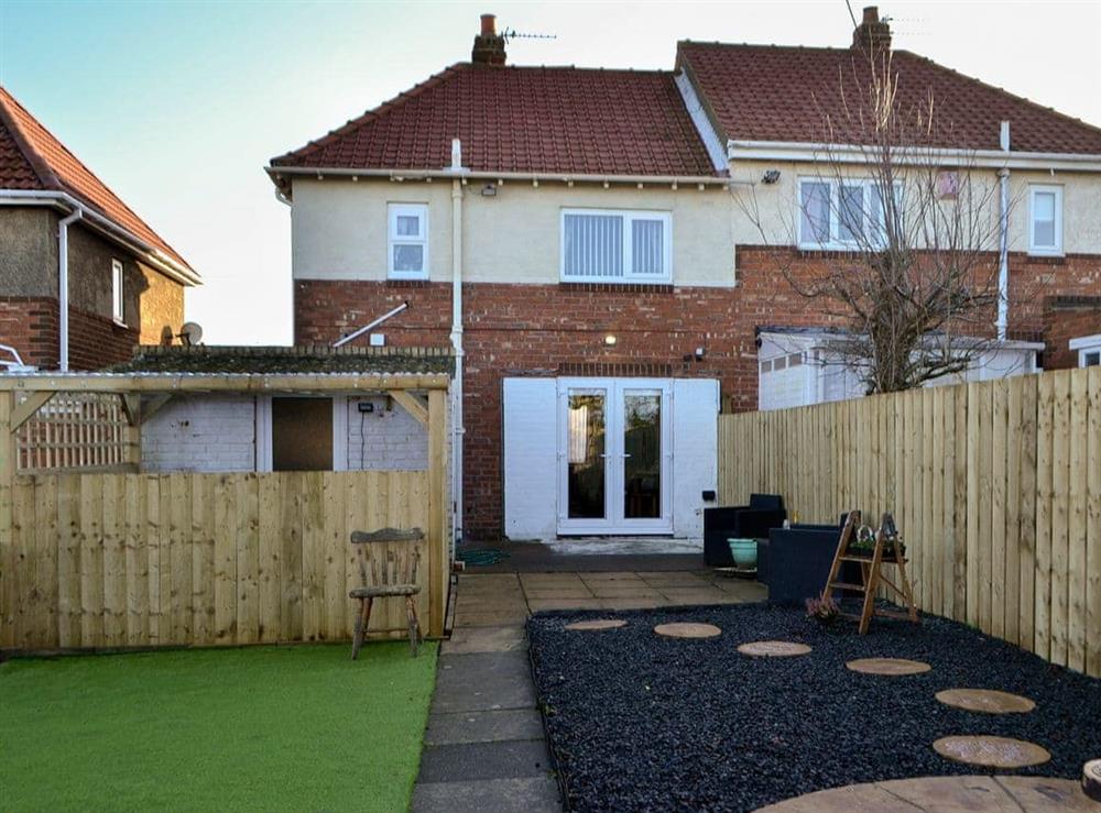 Enclosed garden with astro turf, patio and garden furniture at Seashells by the Sea in Newbiggin-by-the-Sea, Northumberland