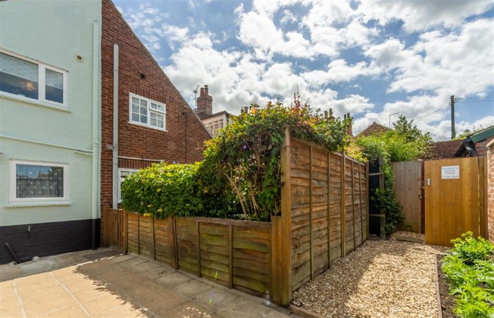 A private courtyard garden with gate access to private parking space at Seaside Cottage, Wells-next-the-Sea