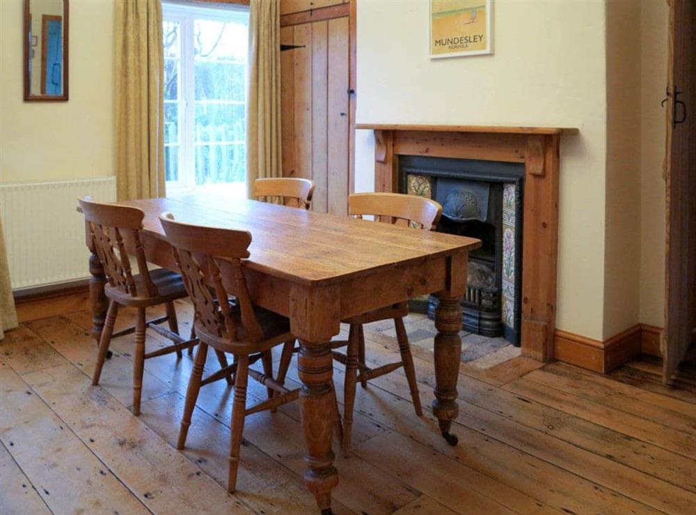 Delightful wooden-floored dining room at Jennys Cottage, 