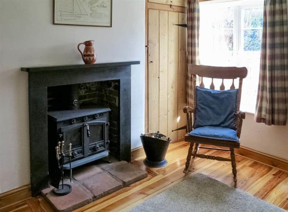Welcoming living room with wood burner at Jennys Cottage, 
