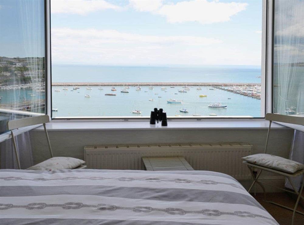 The double bedroom is a great place to watch the bustling harbour from at Seaside Stories in Brixham, Devon