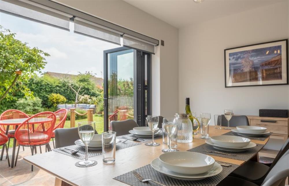 Family meals can be enjoyed even more by extending onto the pretty terrace via the large bi-folding doors