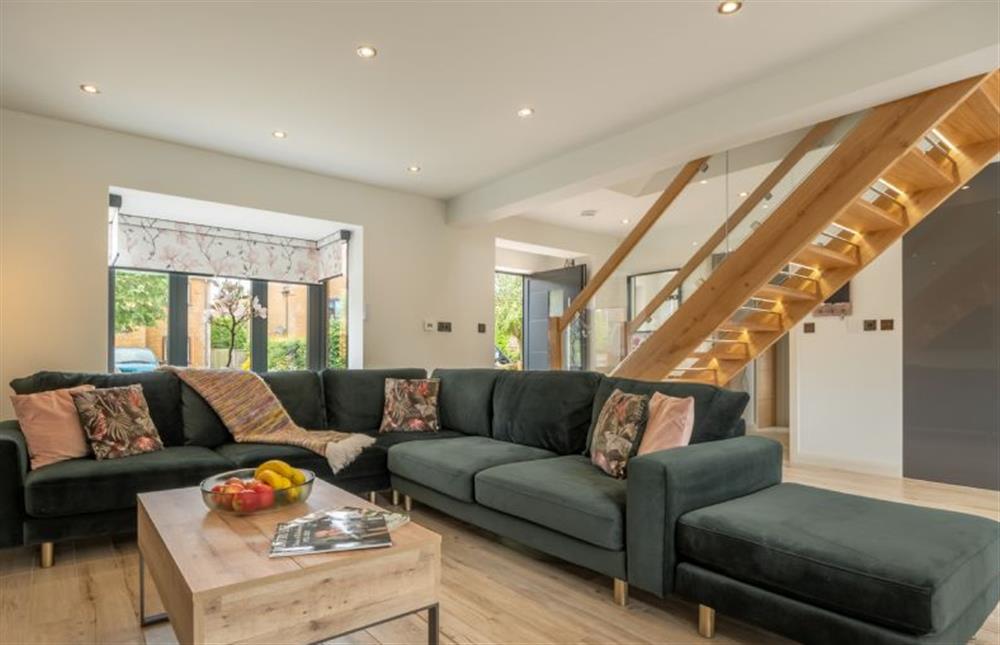 Seaspray, Norfolk: Relaxed seating in front of the cosy wood burning stove within the open-plan living space